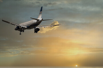 Rear view of a commercial plane full of passengers approaching the runway in the middle of a beautiful sunrise full of harmony. Perfect copy space
