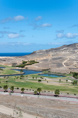 Fototapeta na wymiar golf course among barren slopes, Porto Santo island