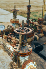 Fototapeta na wymiar Close-Up Of Valve On Pipeline. Oil Or Gas Transportation With Gas Or Pipe Line Valves On Soil And Sunrise Background. Valve pipes, turn off on gas pump vent.