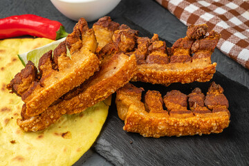 Crispy traditional chicharones pork belly appetizer. Close-up.