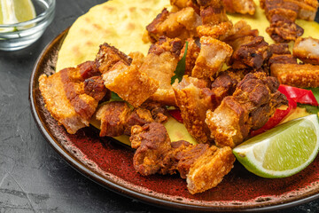 Crispy pieces of pork belly close-up. Snack for beer.
