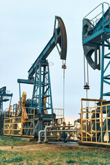 Fototapeta na wymiar Prairie Oil Pump Jacks. Crude oil is a major economic driver. Themes in the image include geology, engineering, pump, rig, well, gas, coal, methane, natural gas, oil, natural resources, and energy.