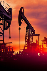 Prairie Oil Pump Jacks. One pump jack producing oil. Crude oil is a major economic driver. Abstract...