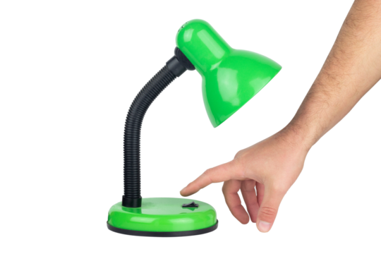 green table lamp with outstretched hand towards the power button, isolated from the background