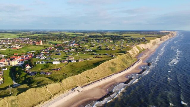 Aerial drone view of the idyllic coast line in Denmark around the village of L&oslash;nstrup on a summer day