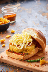 Special Vada Pav isolated on wooden board side view of indian food