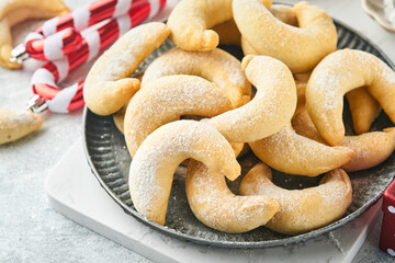 Christmas cookies crescents. Homemade traditional Christmas cookies Vanilla crescents in rustic plate with christmas decorations on gray old background. Food pattern. Holiday baking concept.