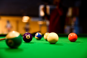 solid and stripe snooker balls on a green snooker table