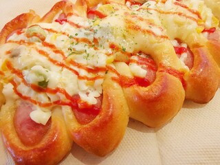Close up of Korean sausage bread containing frankfurter and cheese