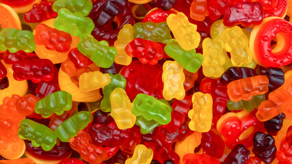 Assorted colorful gummy candies. Jelly donuts. Jelly bears.