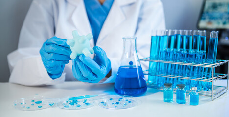 Scientist mixing chemical liquids in the chemistry lab. Researcher working in the chemical laboratory.