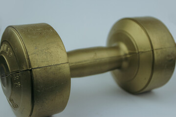 gold color barbell made of plastic with a weight of 2 kg