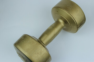 gold color barbell made of plastic with a weight of 2 kg