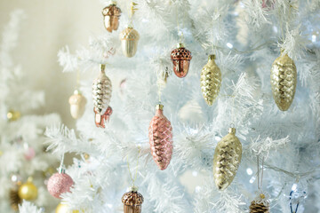 Christmas decoration. Vintage glass cones and acorns on a white Christmas tree