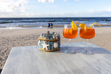 Beach cafe, two drinks on the table. In the background the Baltic Sea and an empty beach, Island...