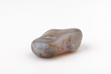 Multicolored gemstones, tumbled minerals. Bostwan agate of various sizes on a white background.