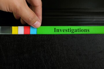 Hand picking investigations file record in black binder folder. Crime, legal and incident...