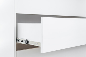 Stainless telescopic bayonet drawer slide guides, installed on a cabinet from white chipboard.