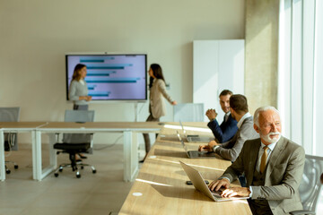 Senior business man working on digital tablet in the office