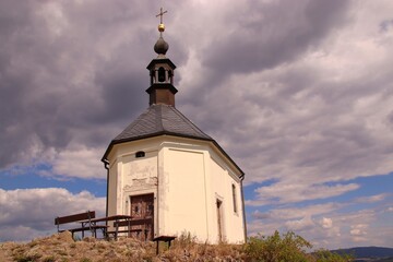 A chapel at the top of the hill with dramatic sky at Vysker, Czech republic