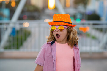 Travel and adventure. Happy child tourist with travel bag travelling. Kid with suitcase traveling on city street outdoor.