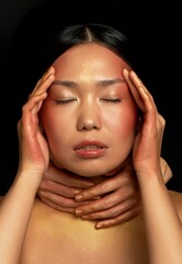 An Asian girl on a black background in the studio. Gold. A state of hopelessness, depression.