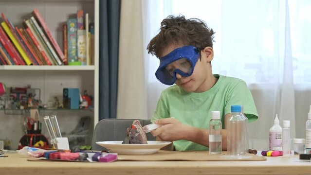 boys cientist doing experiments. Education concept. Preschooler interests. Smart little child doing chemical research at home laboratory. Dangerous experiment. Home activities for children.