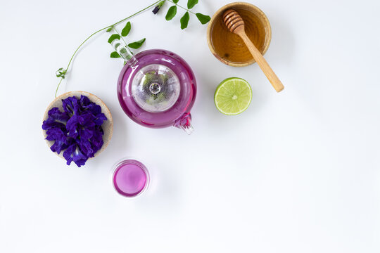 Top view of Butterfly pea flower tea with lemons on white background. Health drink concept..