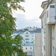 View from window of a low white building on summer day.