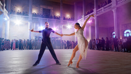 Couple dancers  perform latin dance on large professional stage. Ballroom dancing.