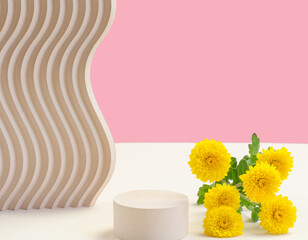 Empty stand for packaging. Cosmetic beauty showcase with yellow chrysanthemum flowers