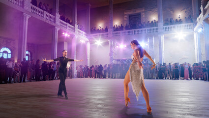 Couple dancers  perform latin dance on large professional stage. Ballroom dancing.