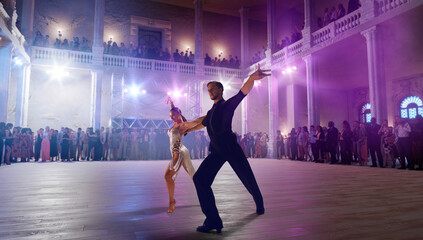 Couple dancers  perform latin dance on large professional stage. Ballroom dancing.