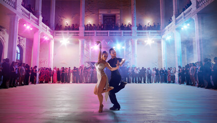 Couple dancers  perform latin dance on large professional stage. Ballroom dancing.