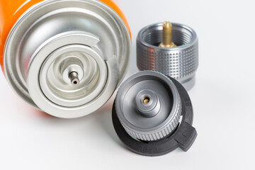 Tourist gas cylinder and gas valves on white background.