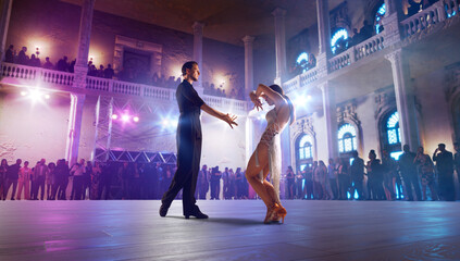 Couple dancers  perform latin dance on large professional stage. Ballroom dancing.