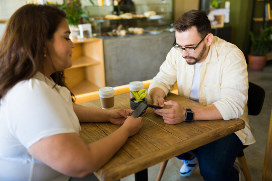 Boyfriend and girlfriend using social media during a date