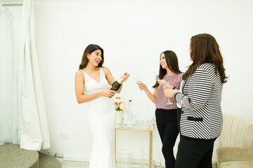 Excited woman and friends celebrating buying a wedding dress