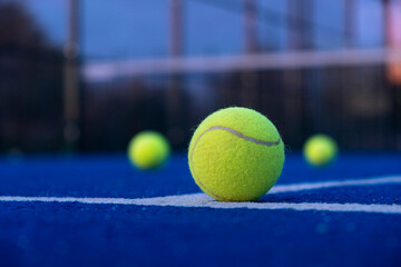 selective focus, three balls on an artificial grass paddle tennis court