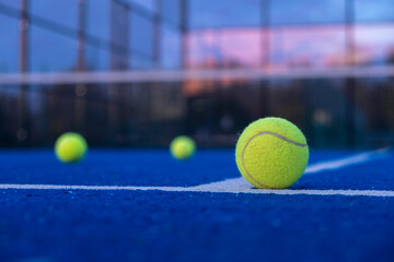 selective focus, three balls on an artificial turf paddle tennis court