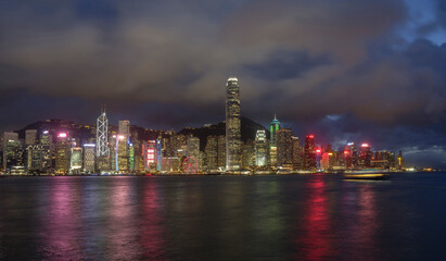 Obraz na płótnie Canvas Night landscape / skyline of Hong Kong Harbour, showing neon-lit skyscrapers.