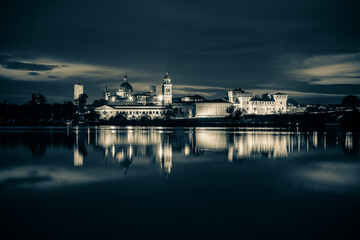 Panoramic evening view of Mantua, Lombardy, Italy; scenic twilight skyline view of the medieval town reflected in the lake waters