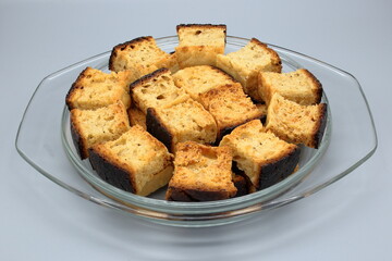 fresh and tasty bread croutons in the kitchen in a glass plate