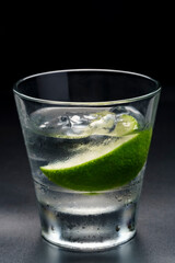 Luxury cocktail Vodka lime mojito, gin tonic with ice, tequila in rocks-glass on black background.