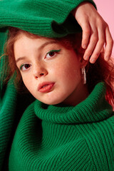 Beautiful fashionable freckled girl with green eyeliner makeup, wearing trendy green knitted turtleneck sweater, hoop earrings. Close up studio portrait
 - obrazy, fototapety, plakaty