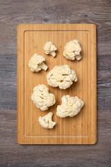 Cauliflower inflorescences on a kitchen board, vegetarian food