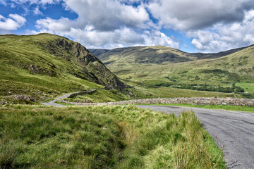 Fototapeta na wymiar lonely pass road in the green landscape of County Mayo, Republik of Ireland