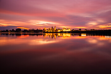 Panoramic evening view of Mantua, Lombardy, Italy; scenic sunset skyline view of the medieval town reflected in the lake waters