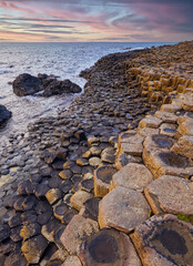 Irish coastline with Volcanic hexagonal basalt columns of Giant`s Causeway at sunset in Northern Ireland