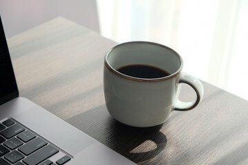 cup of coffee near the laptop